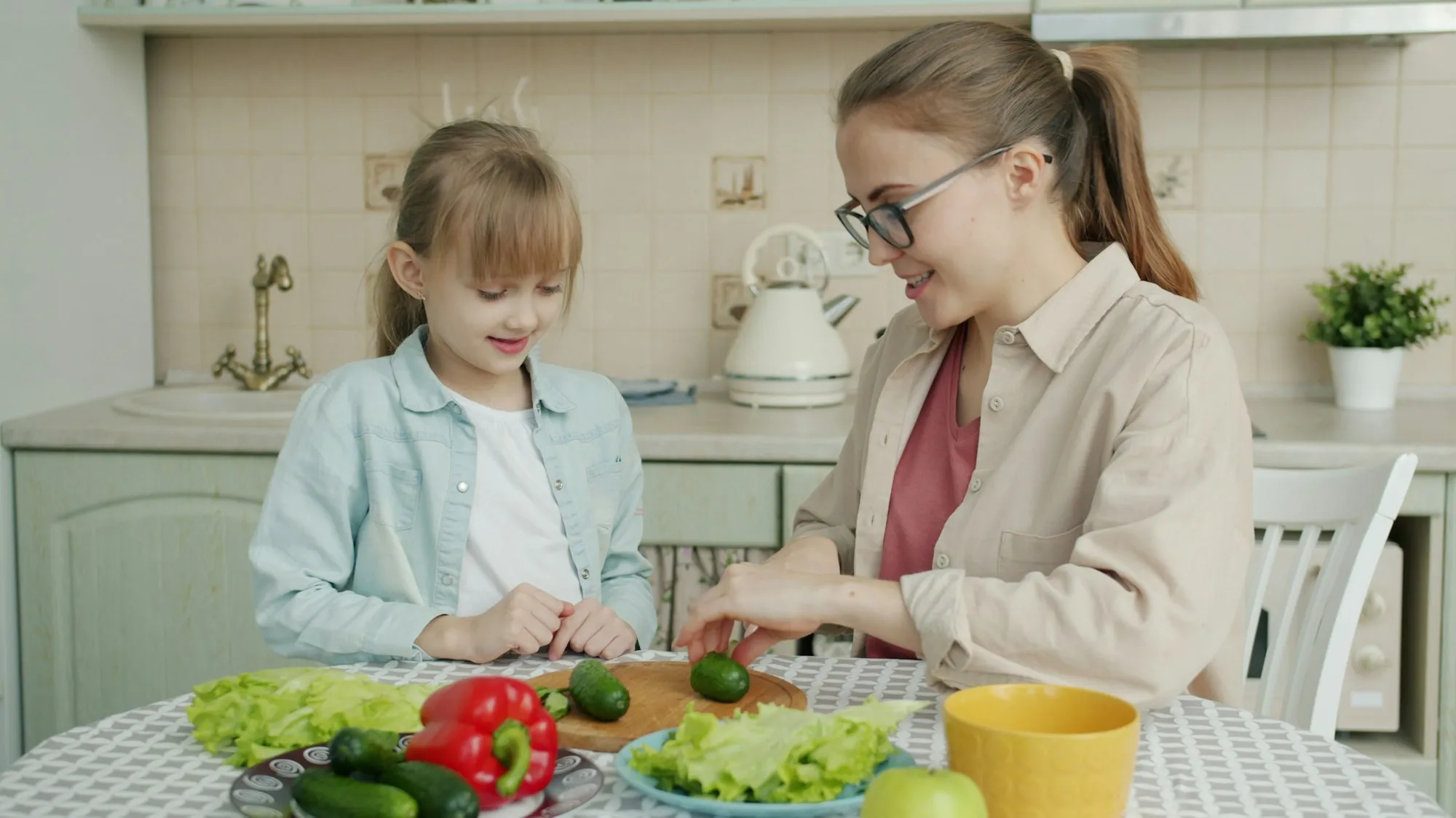 Mother and daughter cooking together in a kitchen