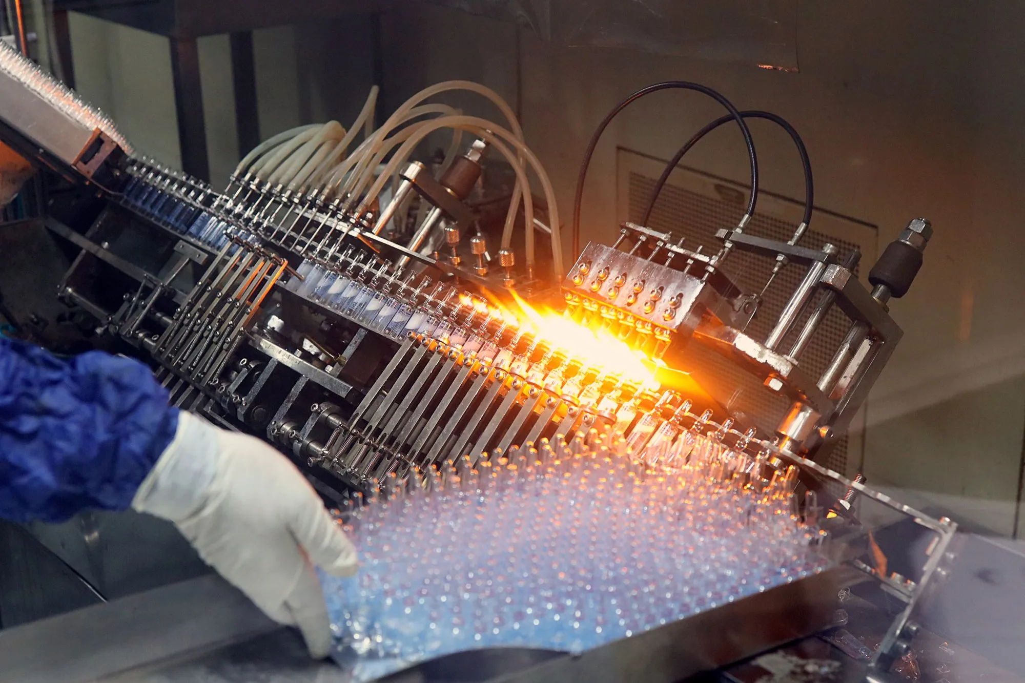 Glass ampoules being filled and sealed on an automated line