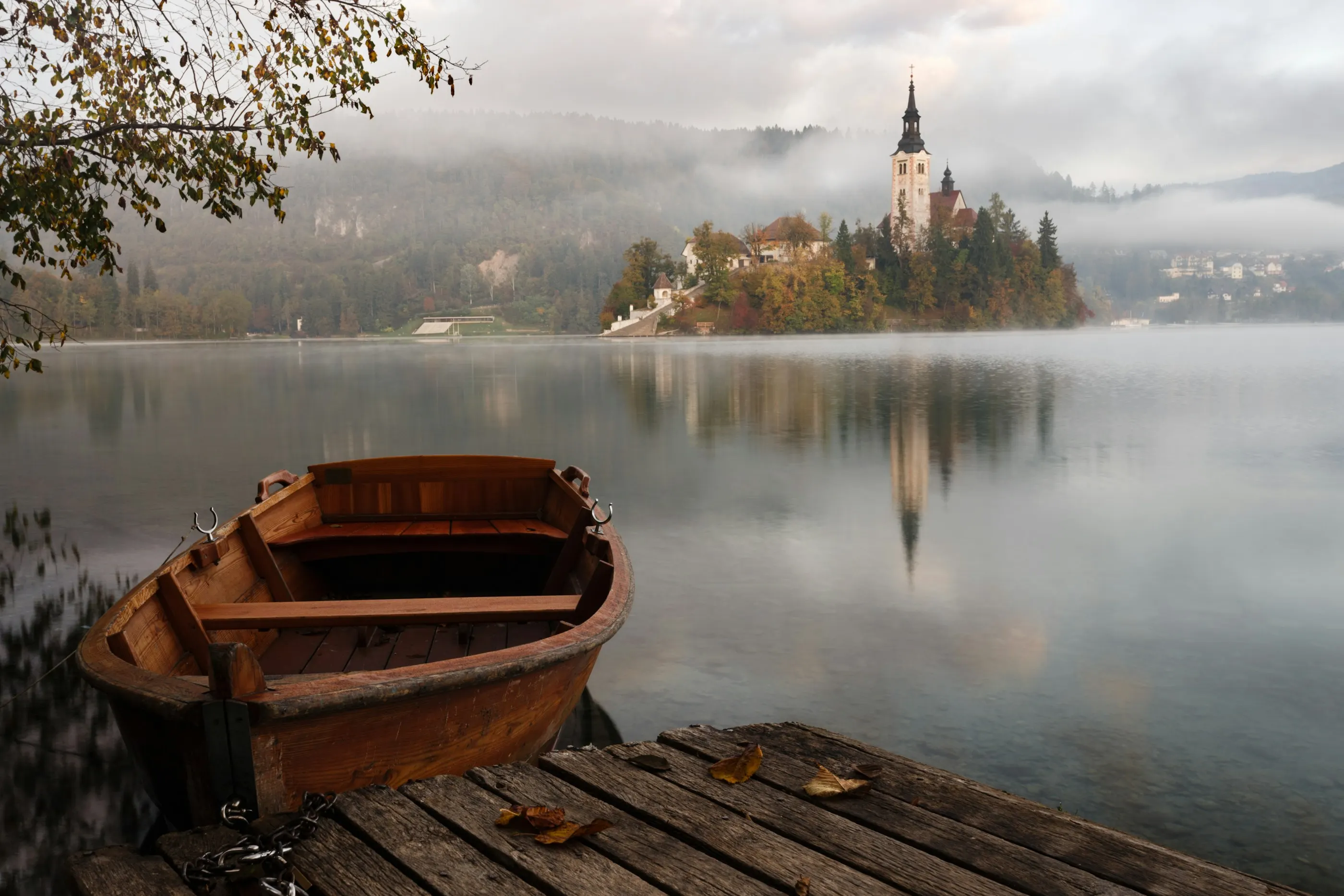 A wooden boat on misty Lake Bled, Slovenia